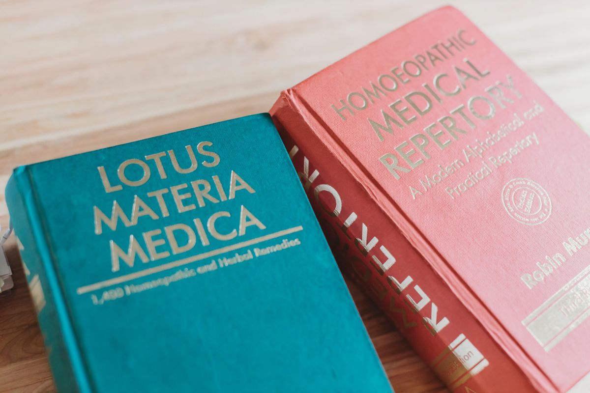 Lotus Materia Medica and a homoeopathic repertory on Van's desk