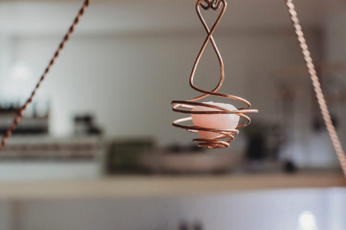 Rose quartz in a copper spiral hanging in the clinic